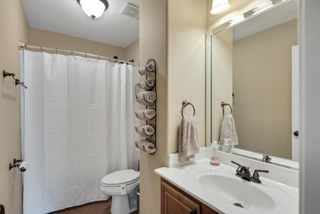 bathroom featuring tile patterned flooring, a shower with shower curtain, vanity, and toilet