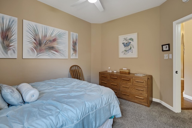 bedroom with ceiling fan and light carpet