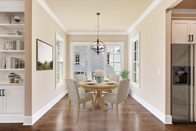 6625 Pidgeon Woods Cv, Memphis, TN 38119 - dining space with dark wood finished floors, an inviting chandelier, baseboards, and ornamental molding