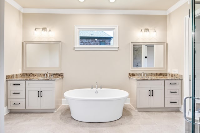 bathroom with a bath, tile patterned floors, crown molding, and vanity