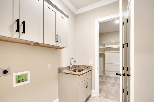 laundry area with light carpet, hookup for a washing machine, hookup for an electric dryer, sink, and cabinets