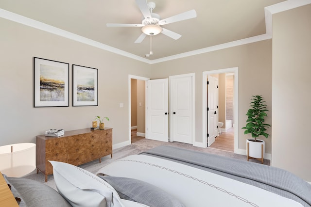 bedroom with ceiling fan, crown molding, and ensuite bath