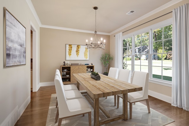 dining area with ornamental molding, a chandelier, and wood-type flooring