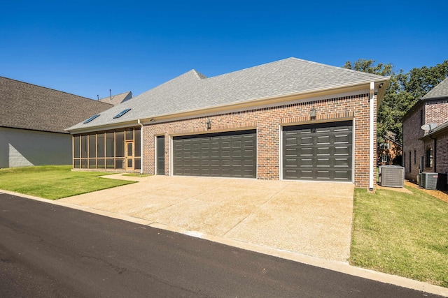 6625 Pidgeon Woods Cv, Memphis, TN 38119 - view of front of home featuring a front yard, brick siding, a sunroom, and an attached garage