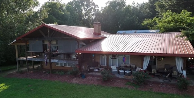 rear view of house with an outdoor living space and a patio