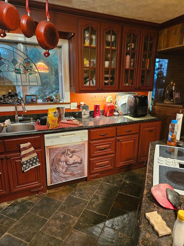 kitchen featuring dishwasher, sink, and a textured ceiling