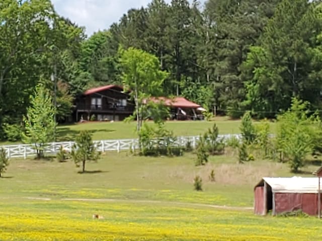 surrounding community with an outbuilding, a rural view, and a lawn