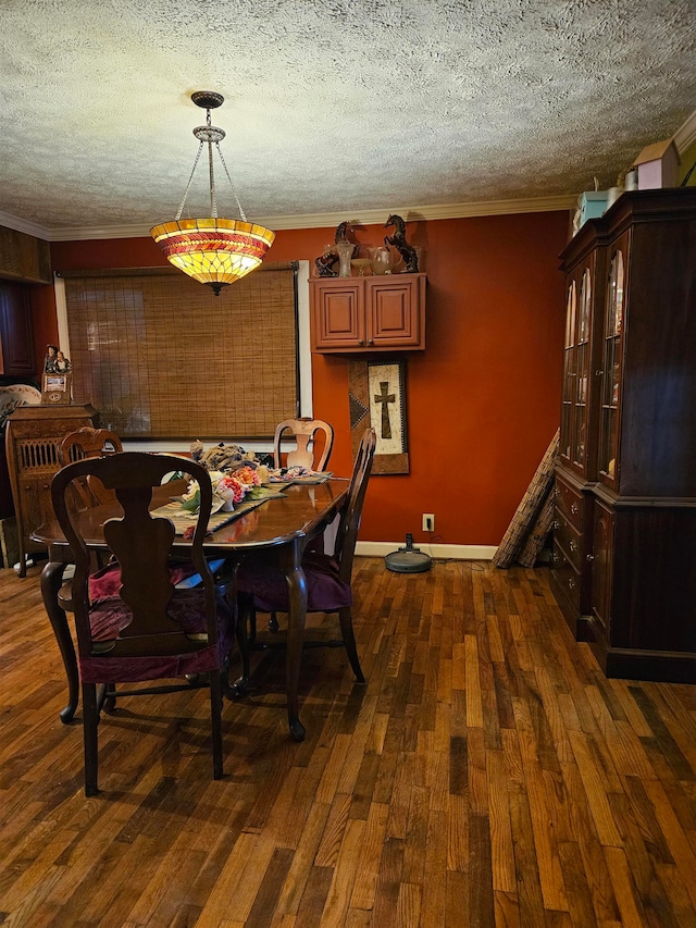 dining area featuring crown molding, dark wood-type flooring, and a textured ceiling