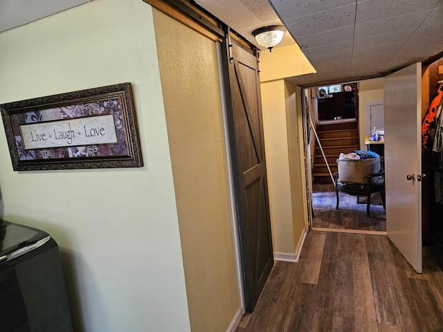 corridor featuring hardwood / wood-style floors and a barn door