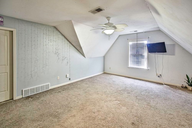 additional living space with vaulted ceiling, carpet floors, and ceiling fan