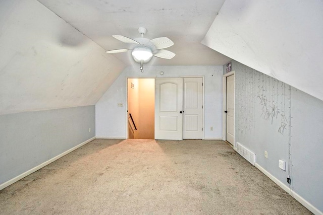 additional living space with vaulted ceiling, carpet flooring, and ceiling fan