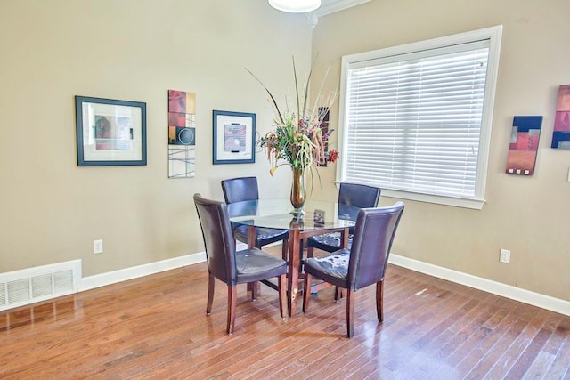 dining room featuring crown molding and wood-type flooring