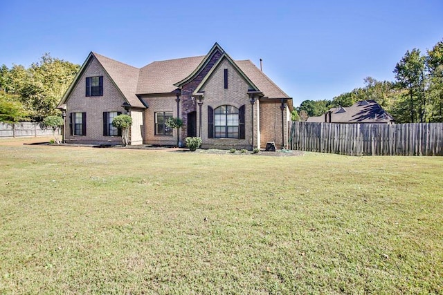 french provincial home with a front yard