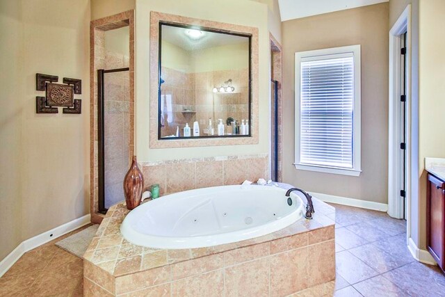 bathroom featuring vanity, plus walk in shower, and tile patterned floors