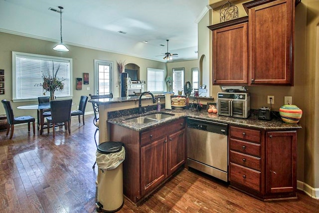 kitchen with dark hardwood / wood-style flooring, ceiling fan, stainless steel dishwasher, pendant lighting, and sink