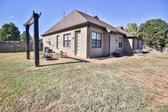 rear view of property featuring a yard, a patio, and central AC unit