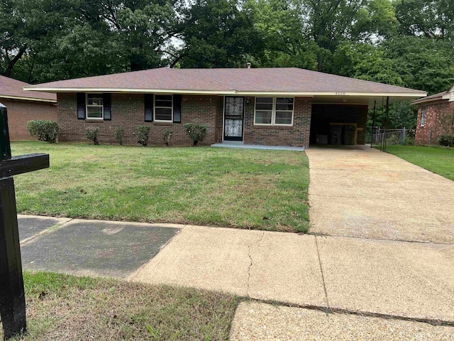 ranch-style home with a garage and a front lawn