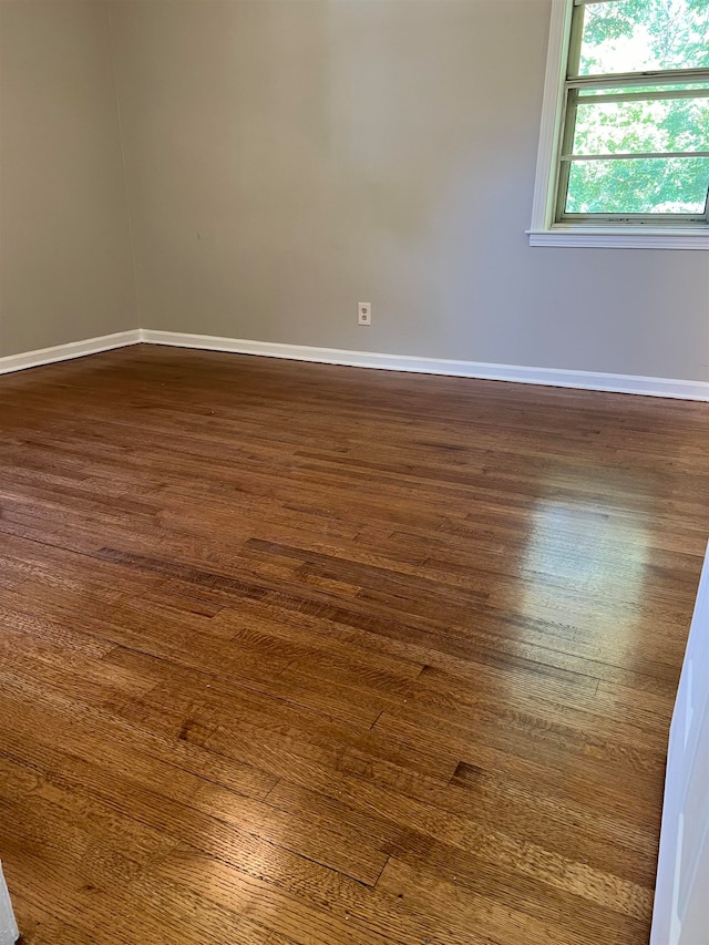 unfurnished room with dark hardwood / wood-style floors