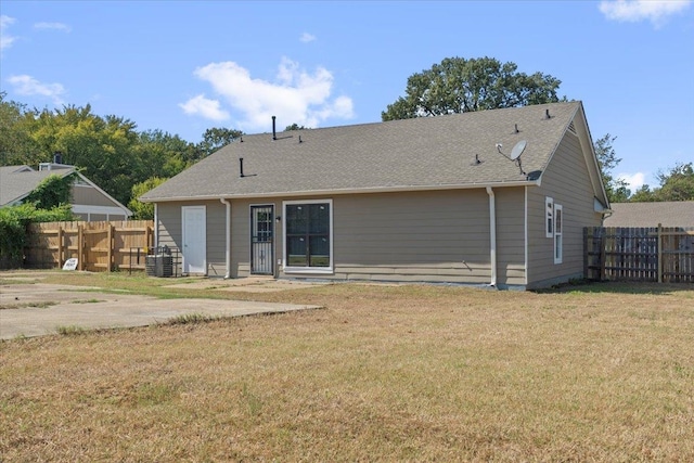 rear view of property with a lawn