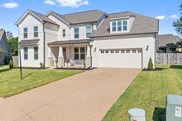 view of front of house featuring a front yard and a garage