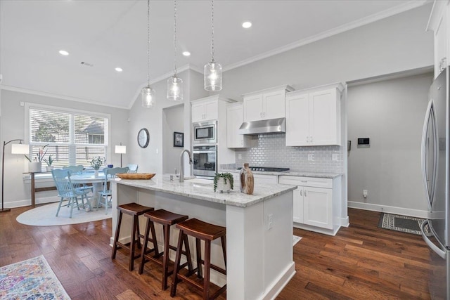 kitchen featuring a kitchen island with sink, crown molding, stainless steel appliances, dark hardwood / wood-style floors, and white cabinets