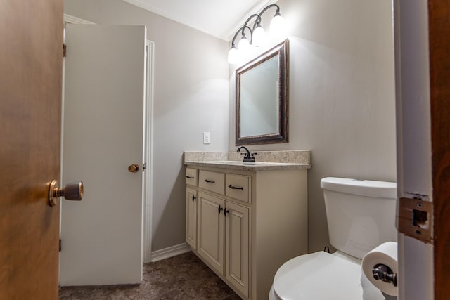 bathroom with crown molding, vanity, and toilet