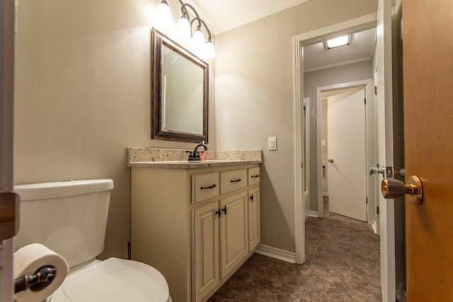 bathroom featuring ornamental molding, vanity, and toilet