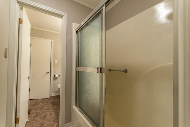 bathroom with bath / shower combo with glass door, crown molding, and toilet