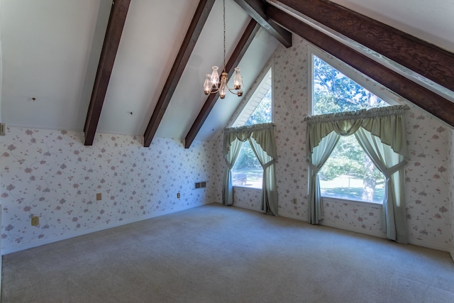 additional living space with lofted ceiling with beams, a notable chandelier, plenty of natural light, and carpet floors