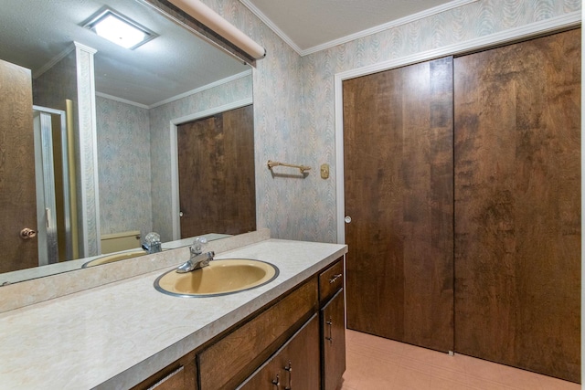 bathroom with crown molding, tile patterned flooring, and vanity