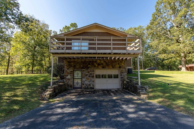 view of front of home with a garage, a front yard, central AC, and a deck