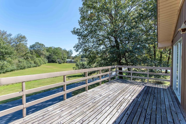 wooden terrace with a yard