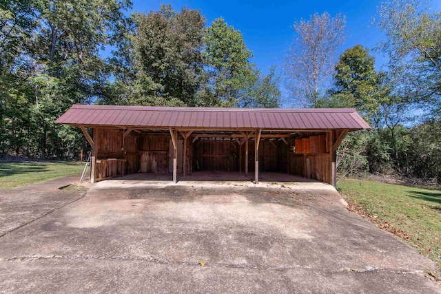 view of vehicle parking featuring a yard and a carport