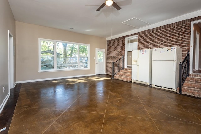 unfurnished living room featuring brick wall and dark tile patterned floors