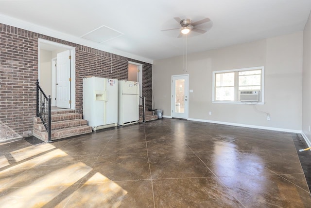 unfurnished living room with brick wall, cooling unit, and ceiling fan