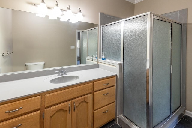 bathroom with walk in shower, vanity, and toilet