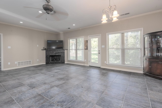 unfurnished living room with ceiling fan with notable chandelier, crown molding, and a tiled fireplace