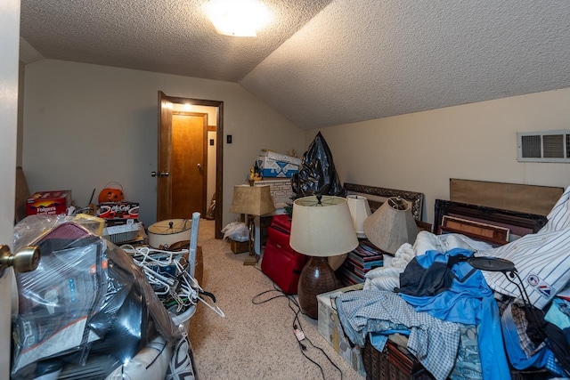 bedroom featuring a textured ceiling, vaulted ceiling, and carpet