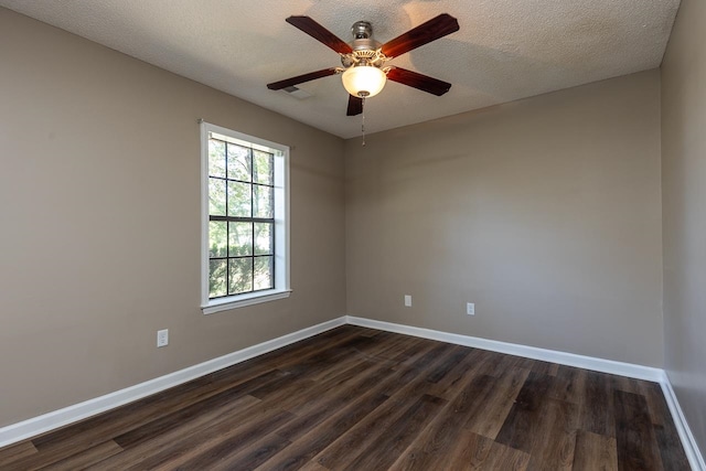 spare room featuring ceiling fan, dark hardwood / wood-style floors, and a textured ceiling