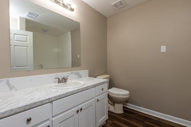 bathroom featuring vanity, toilet, and wood-type flooring