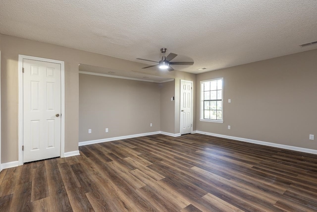 unfurnished room with ceiling fan, a textured ceiling, and dark wood-type flooring