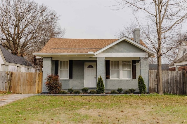 bungalow-style house with a porch and a front lawn