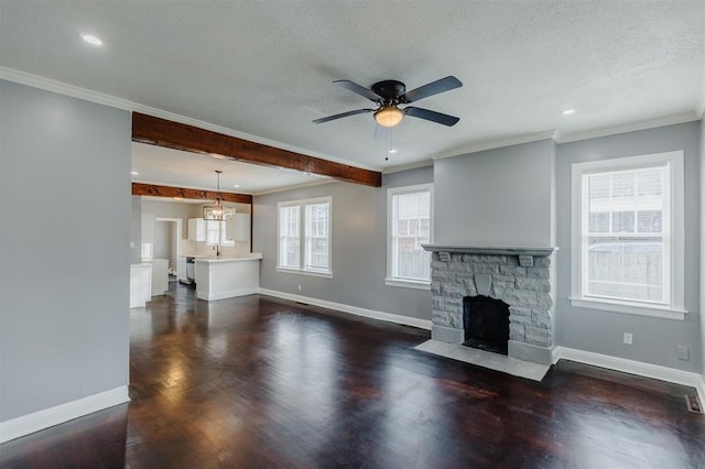 unfurnished living room with a fireplace, a wealth of natural light, dark hardwood / wood-style floors, and crown molding