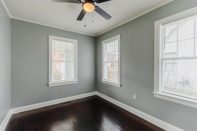 empty room featuring ornamental molding, ceiling fan, and wood-type flooring