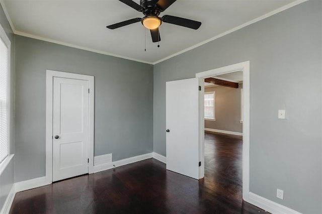 spare room with crown molding, ceiling fan, and dark hardwood / wood-style flooring