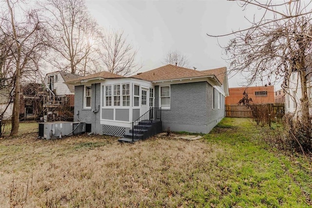 rear view of property with a lawn