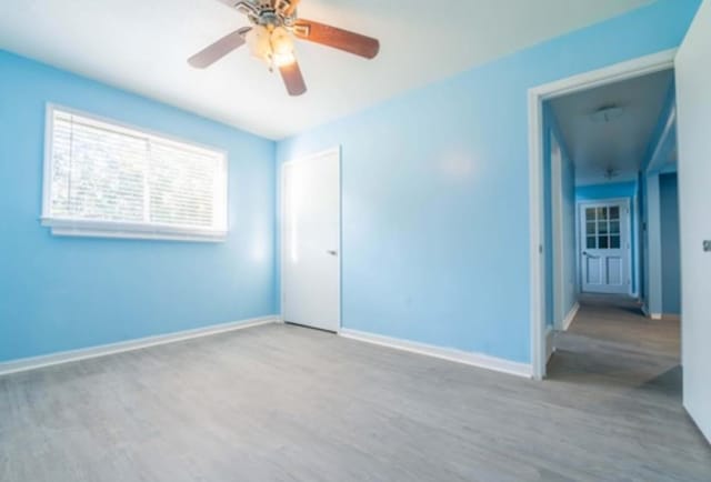 empty room with wood-type flooring and ceiling fan