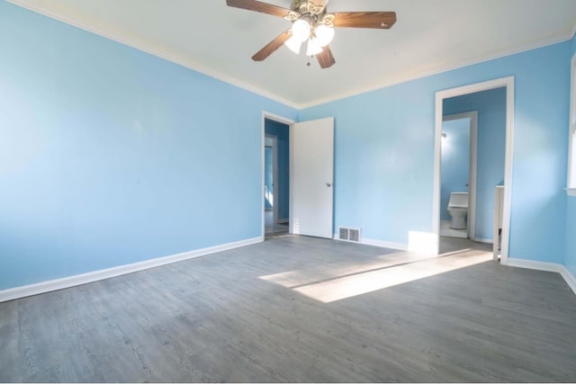 empty room featuring dark hardwood / wood-style floors and crown molding