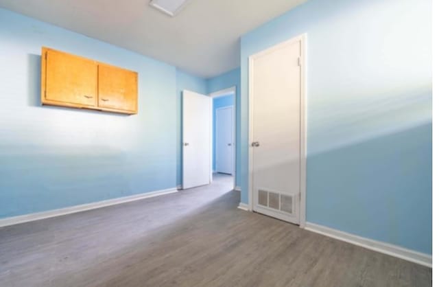 unfurnished room featuring dark hardwood / wood-style flooring