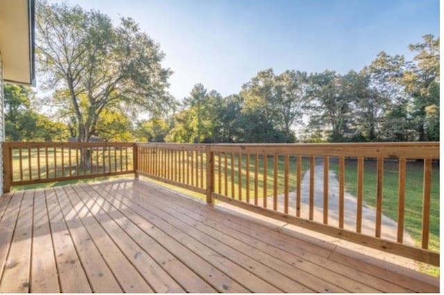 wooden deck with a lawn